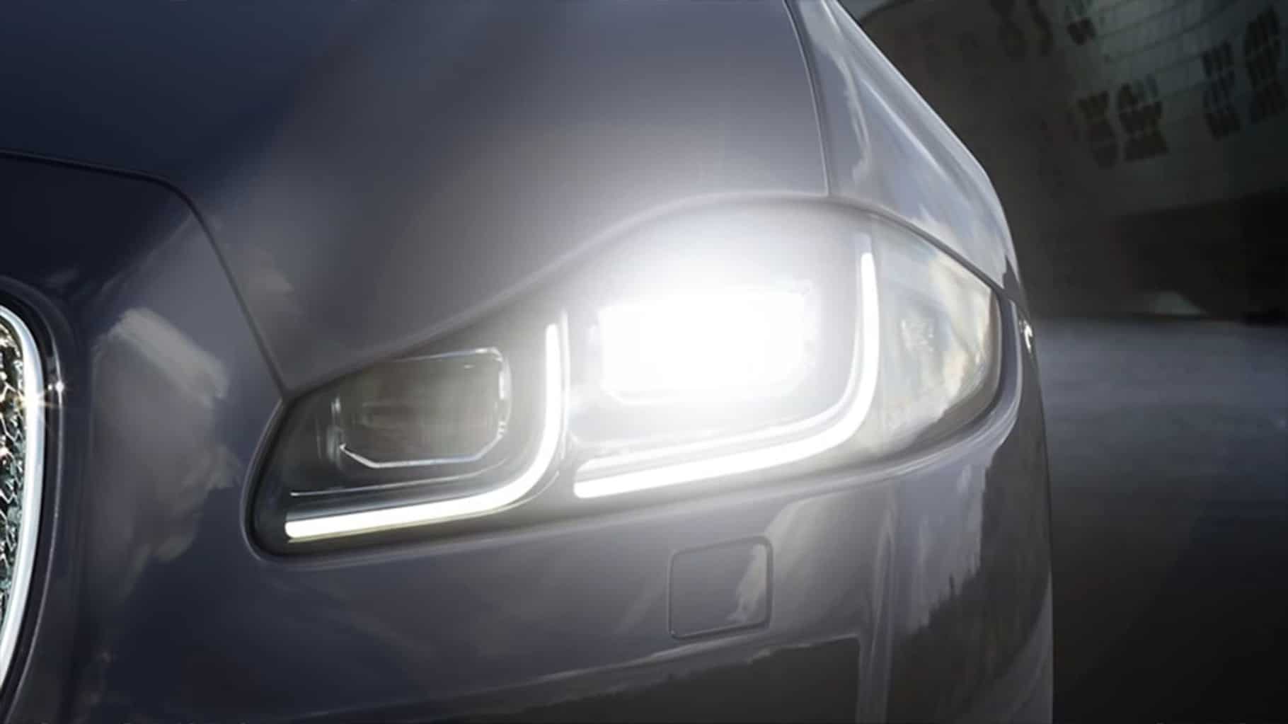 Close-up of Jaguar XJ's automatic headlights and intelligent high beam assist.