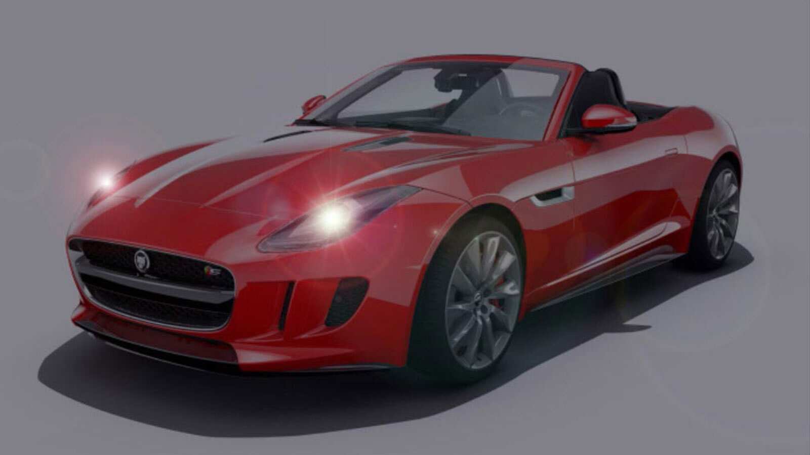 A Red Jaguar With The Headlights Turned On
